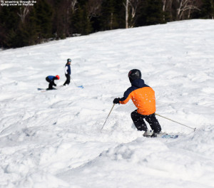 An image of Ty skiing spring moguls on the Hayride trail at Stowe Mountain Resort in Vermont