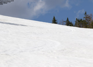 An image of May ski tracks in spring snow on the slopes of Spruce Peak at Stowe Mountain Resort in Vermont