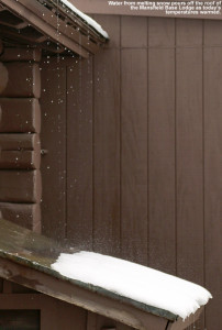 An image of melted snow pouring off the roof of the Mansfield Base Lodge at Stowe Mountain Resort in Vermont