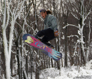 An image of a snowboarder jumping at Stowe Mountain Resort in Vermont