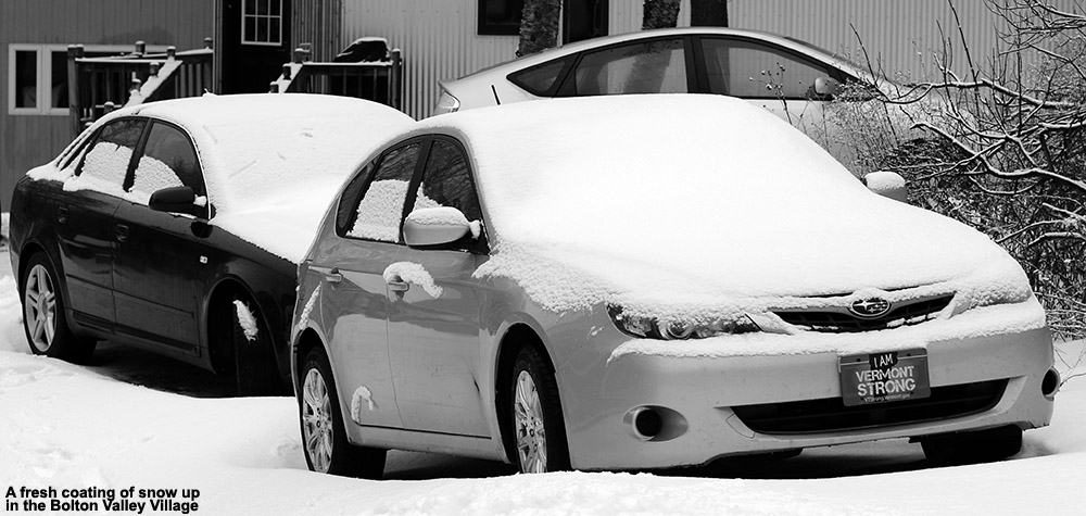 An image of cars in the Village at Bolton Valley Ski Resort in Vermont with fresh snow on them
