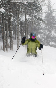 An image of Erica skiing some deep snow in the Nosedive Glades at Stowe Mountain Resort in Vermont