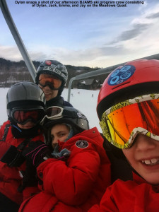 An image of Jay, Jack, Emma, and Dylan on the Meadows Quad Chair at Stowe Mountain Resort in Vermont