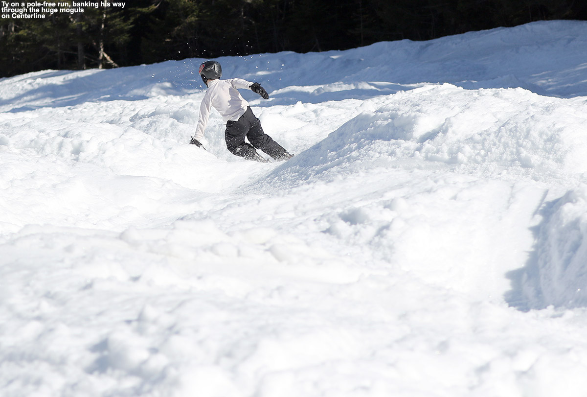 An image of Ty skiing among large moguls in the spring on the Centerline trail at Stowe Mountain Resort in Vermont