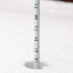 An image showing the depth of snow just outside the Octagon at Stowe Mountain Resort after a May snowstorm