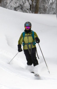 An image of Erica skiing in powder at Bolton Valley Resort in Vermont