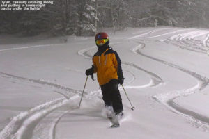 An image of Dylan Telemark skiing in powder at night under the lights at Bolton Valley Resort in Vermont