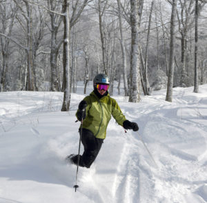 An image of Erica skiing some powder snow in the Wilderness Woods area of Bolton Valley Resort in Vermont