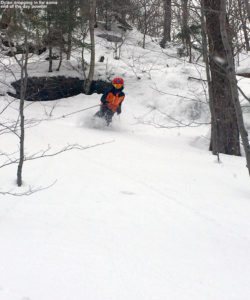 An image of Dylan skiing some powder along the boundary of Spruce Peak at Stowe Mountain Resort in Vermont