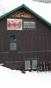 An image showing the "South of Solitude" sign on the Timberline Base Lodge at Bolton Valley Ski Resort in Vermont