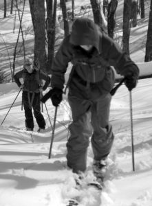 An image of Ty skinning while Erica looks on in the Lincoln Gap area of Vermont