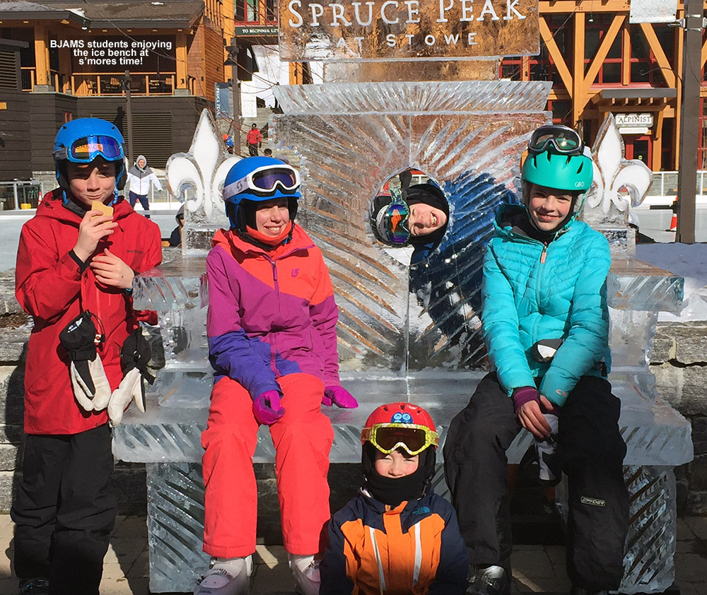An image of some BJAMS students on the ice bench in the Spruce Peak Village at Stowe Mountain Resort in Vermont