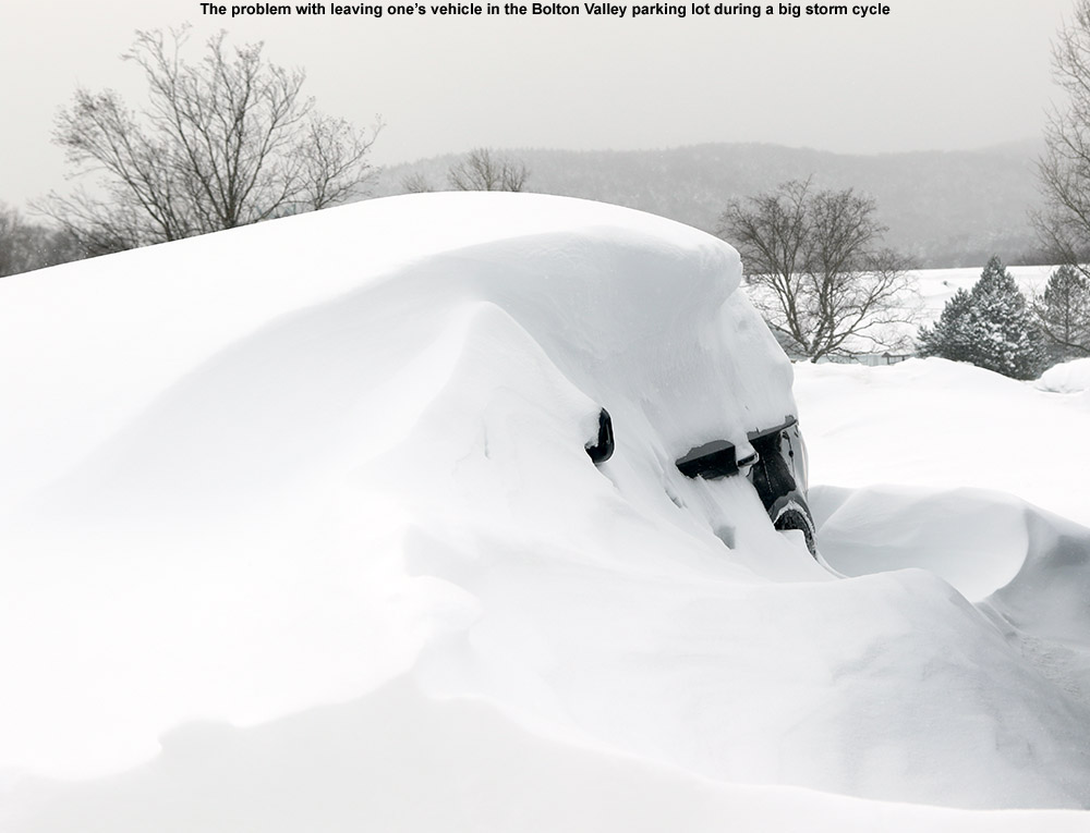 An image of a car, barely visible under drifted snow at Bolton Valley Ski Resort in Vermont