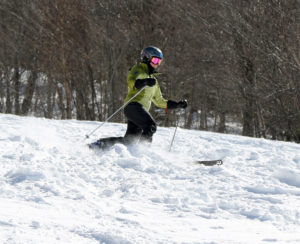 An image of Erica Telemark skiing chopped up snow on the Tattle Tale trail at Bolton Valley Resort in Vermont 