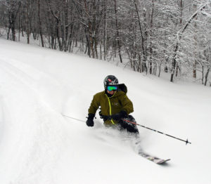 An image of Jay Telemark skiing in powder at Bolton Valley Resort in Vermont