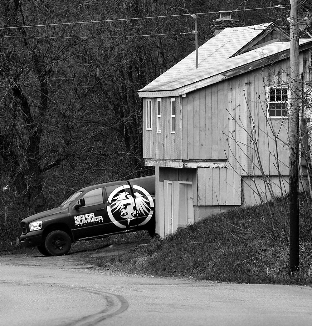 An image of a house with a "Never Summer" truck along the route to Stowe in Moscow, Vermont