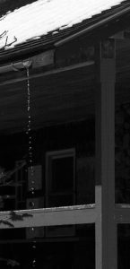 An image of water pouring from a gutter at the Hermit Lake Caretaker's Cabin near Mt. Washington in New Hampshire