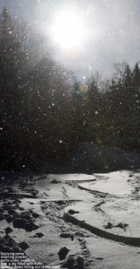 An image of ski tracks in powder snow and snowflakes in the air at Bolton Valley Resort in Vermont