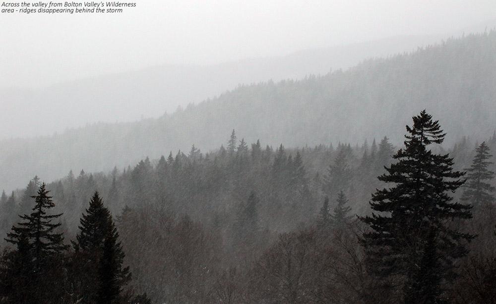 An image of ridgelines in the Bolton Valley Reosrt area in Vermont disappearing behind snow from a December storm