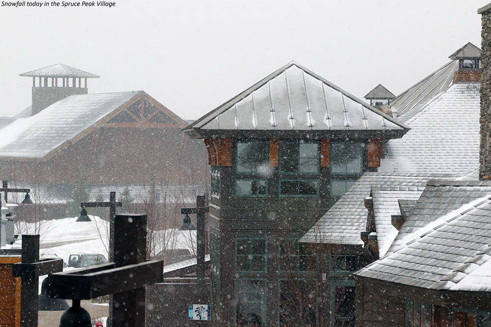 An image of snow falling in the Spruce Peak Village at Stowe Mountain Resort in Vermont