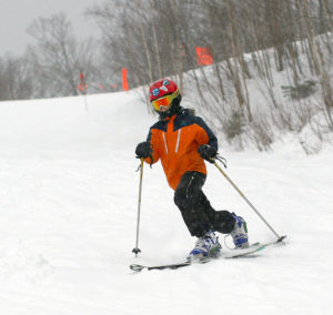 An image of Dylan making a Telemark turn at Stowe Mountain Ski Resort in Vermont