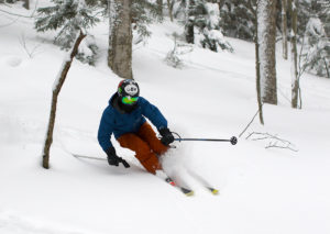 An image of Ty skiing powder in the Villager Trees at Bolton Valley Resort in Vermont