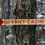An image of a sign on the Bryant Trail indicating the direction of Bryant Cabin at Bolton Valley Ski Resort in Vermont
