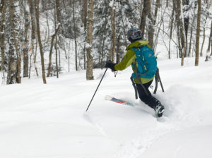 An image of Erica skiing in the backcountry area of Bolton Valley Ski Resort in Vermont