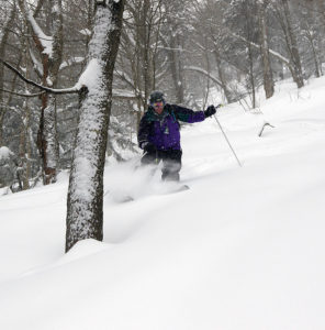 An image of Stephen skiing powder in the backcountry near Bolton Valley Ski Resort in Vermont