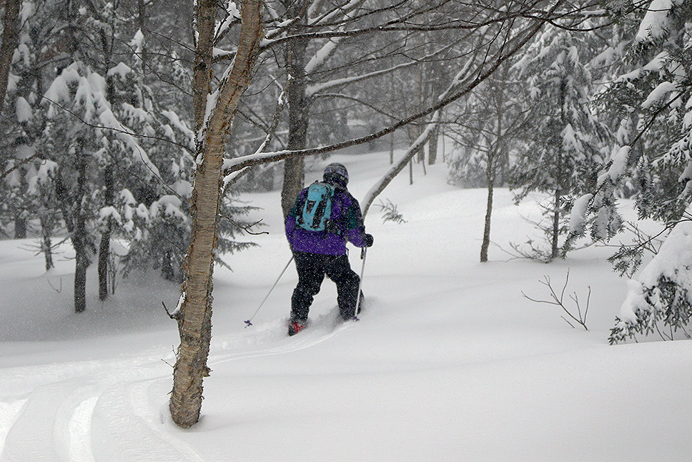 An image of Stephen dropping off Heavenly Highway into some powder on the backcountry network at Bolton Valley Resort in Vermont