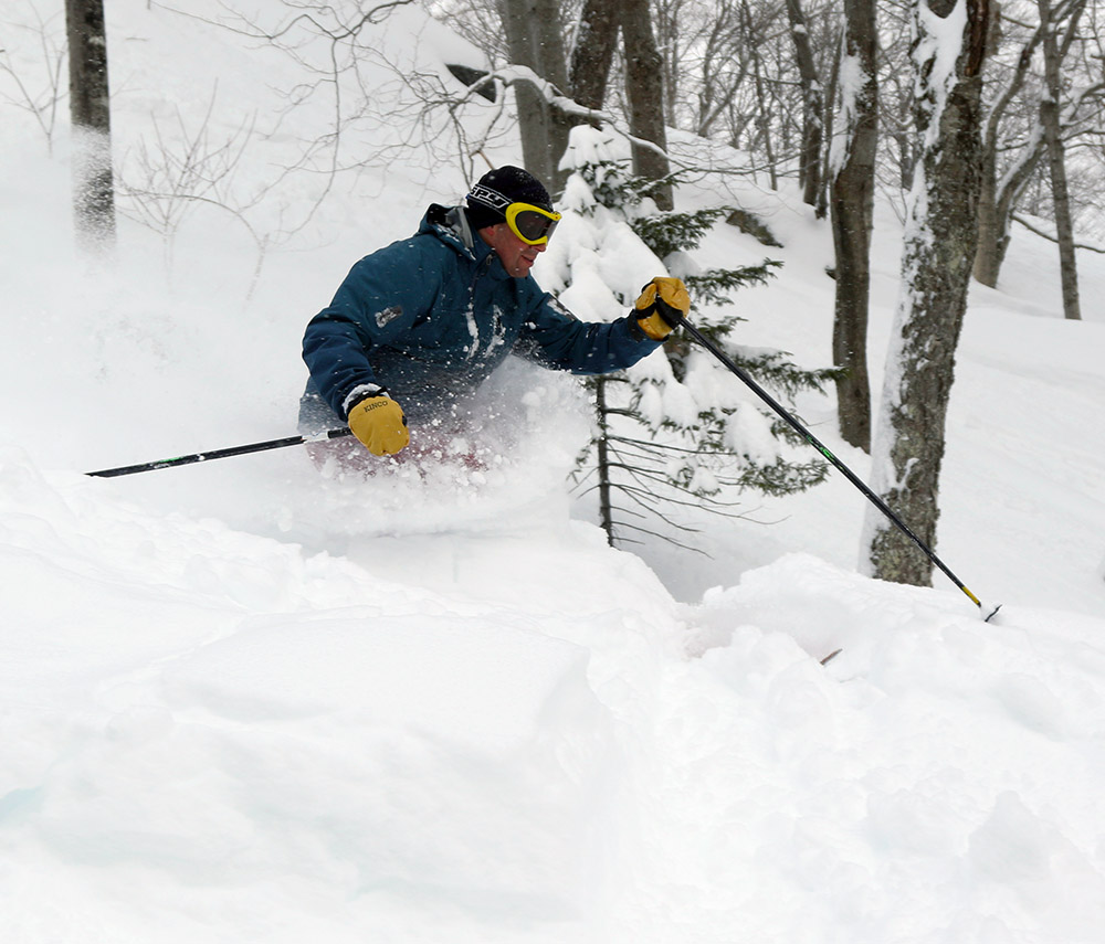 An image of Dave skiing waist deep powder at Stowe Mountain Resort in Vermont