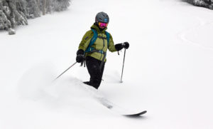 An image of Erica skiing powder near the Vista Summit at Bolton Valley Ski Resort in Vermont