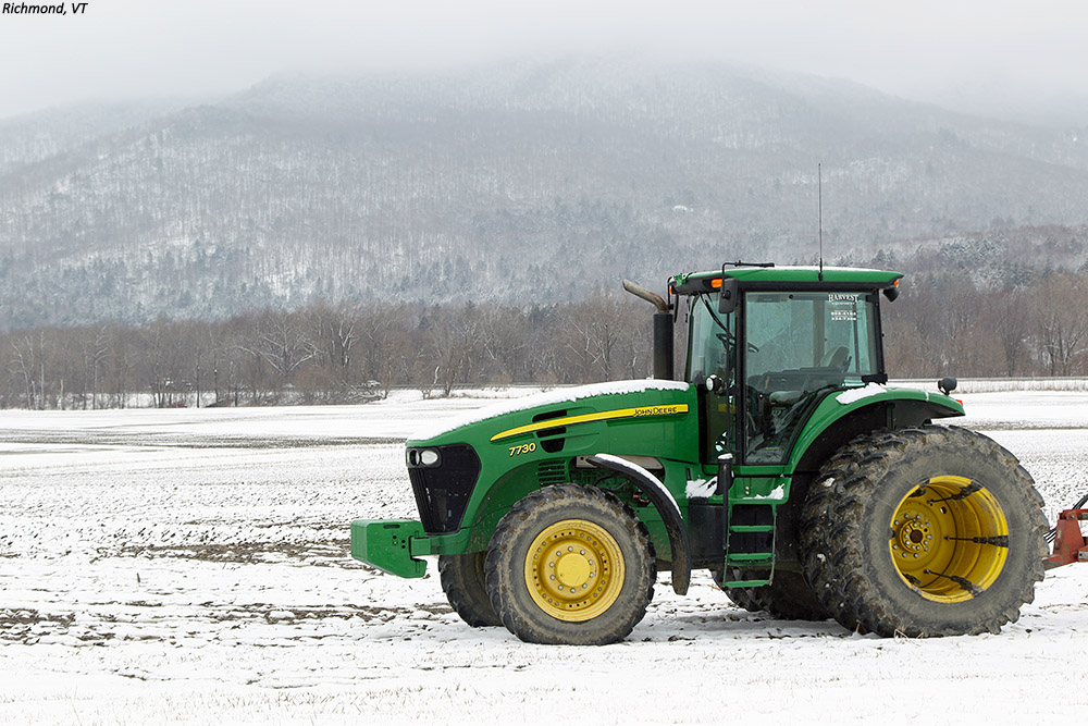 An image of a tractor with snow in Richmond Vermont after an April snowstorm