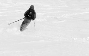 An image of Ty skiing some fresh snow in late April on the Nosedive trail at Stowe Mountain Resort in Vermont
