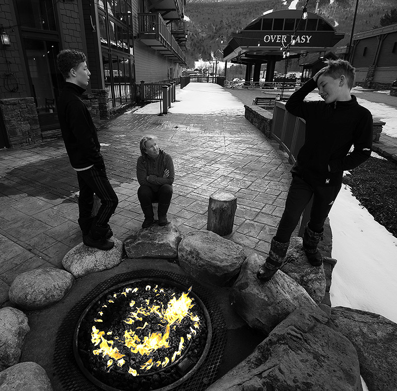 Erica, Ty, and Dylan standing around the fire pit outside the Solstice Restaurant at Stowe Mountain Resort in Vermont