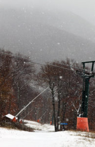 An image the Crossover trail and mountains in the background at Stowe Mountain Resort during an October snowstorm
