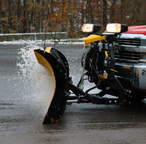 An image of a plow spraying some very slushy snow at Stowe Mountain Resort in Vermont after an October nor'easter snowstorm