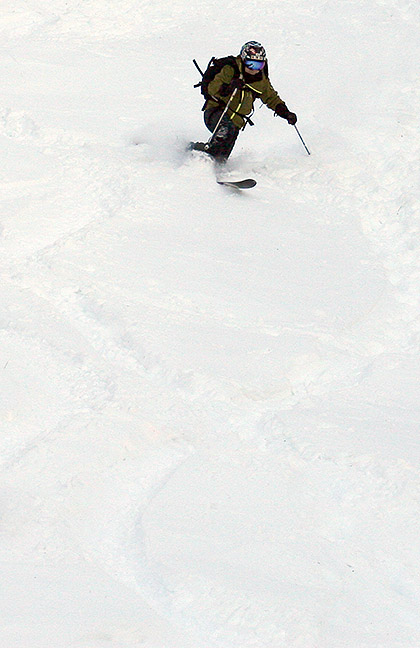 An image of Jay Telemark skiing in powder from a November snowstorm at Bolton Valley Ski Resort in Vermont
