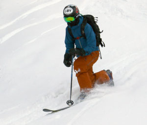 An image of Ty Telemark skiing in powder after a November snowstorm at Bolton Valley Resort in Vermont