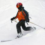 An image of Dylan Telemark skiing in powder after a November snowstorm at Bolton Valley Ski Resort in Vermont