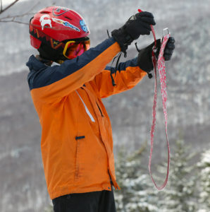 An image of Dylan getting ready to pack up his climbing skins during a November ski tour at Bolton Valley Resort in Vermont
