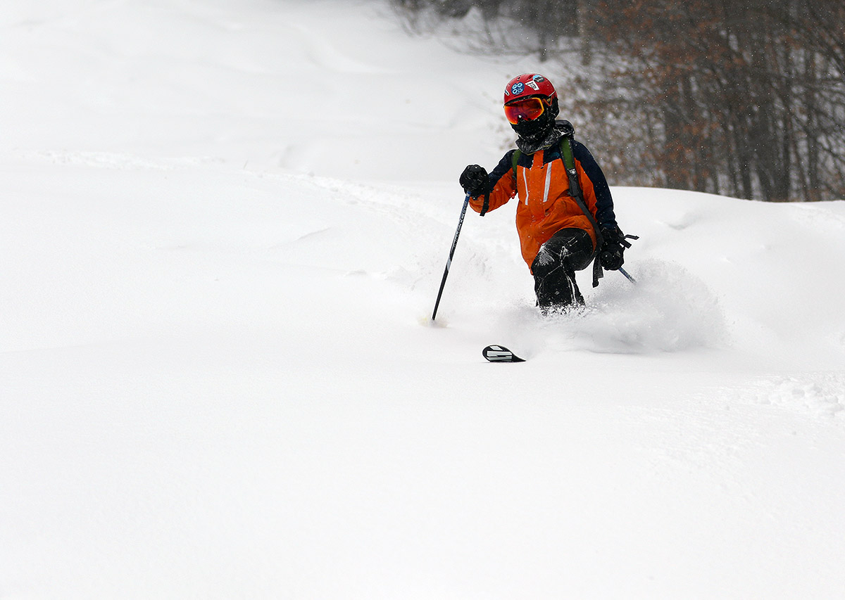 An image of Dylan skiing powder after a snow squall at Bolton Valley Resort in Vermont