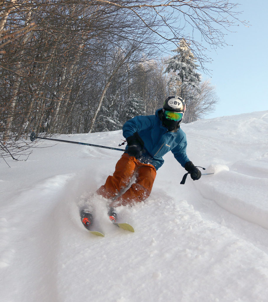 An image of Ty skiing powder on the Valley Road trail at Bolton Valley Resort in Vermont