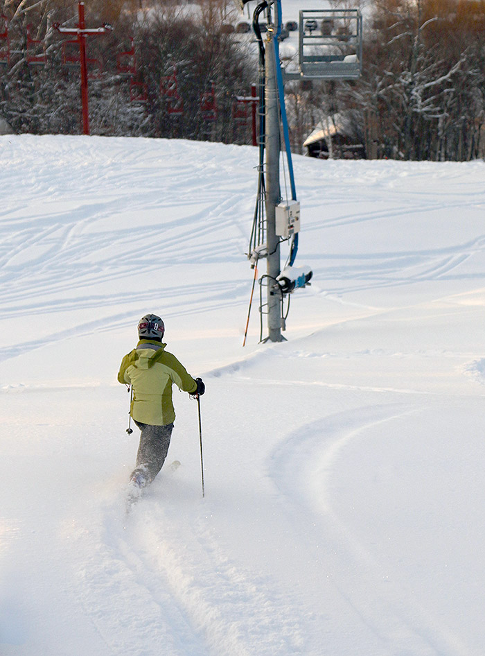 An image of Erica skiing powder on the Valley Road trail at Bolton Valley Resort in Vermont