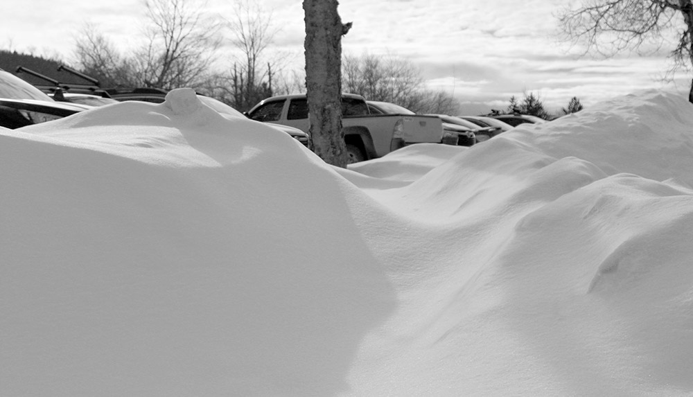 An image of snow banks in the parking lots near the village at Bolton Valley Ski Resort in Vermont
