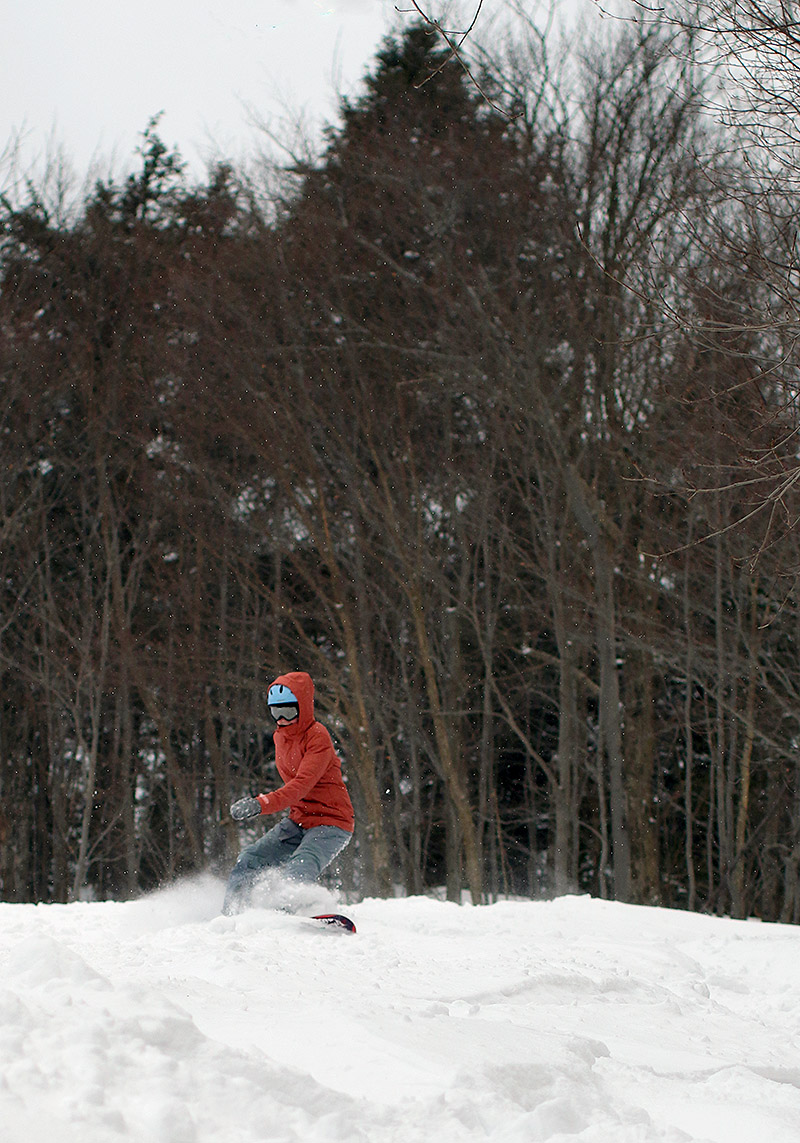 An image of Molly snowboarding on the Upper Meadows trail at Stowe Mountain Resort in Vermont