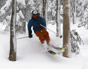 An image of Ty skiing powder snow in the trees at Bolton Valley Ski Resort in Vermont
