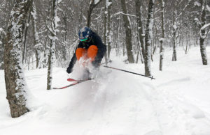 An image of Ivan jumping in powder snow at RASTA's Brandon Gap backcountry recreation area in Vermont.