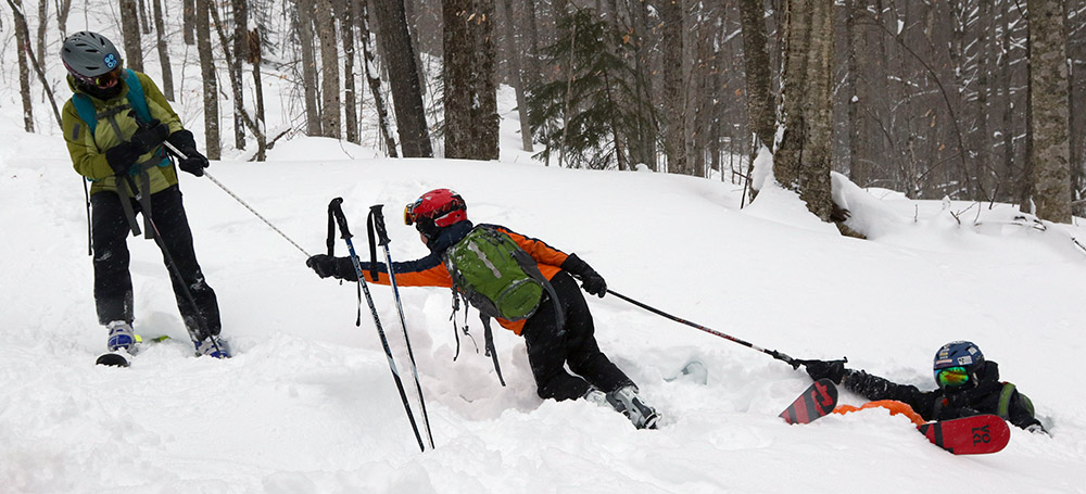 An image of Erica and Dylan helping Ivan out of the powder snow during a ski tour at the Brandon Gap Backcountry Recreation Area in Vermont