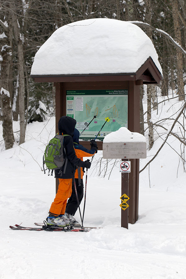 An image of Ivan and Dylan looking at the map at one of the trailheads at RASTA's Brandon Gap Backcountry Recreation Area in Vermont
